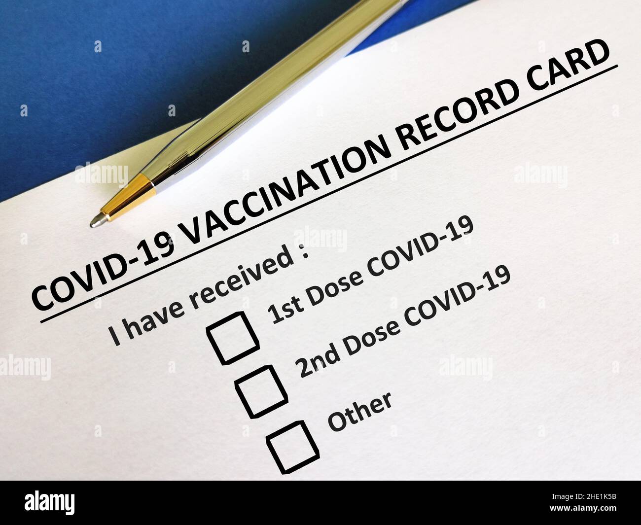 Eine Person beantwortet Fragen zu Impfstoffen. Die Person füllt die COVID-19-Karte auf. Stockfoto