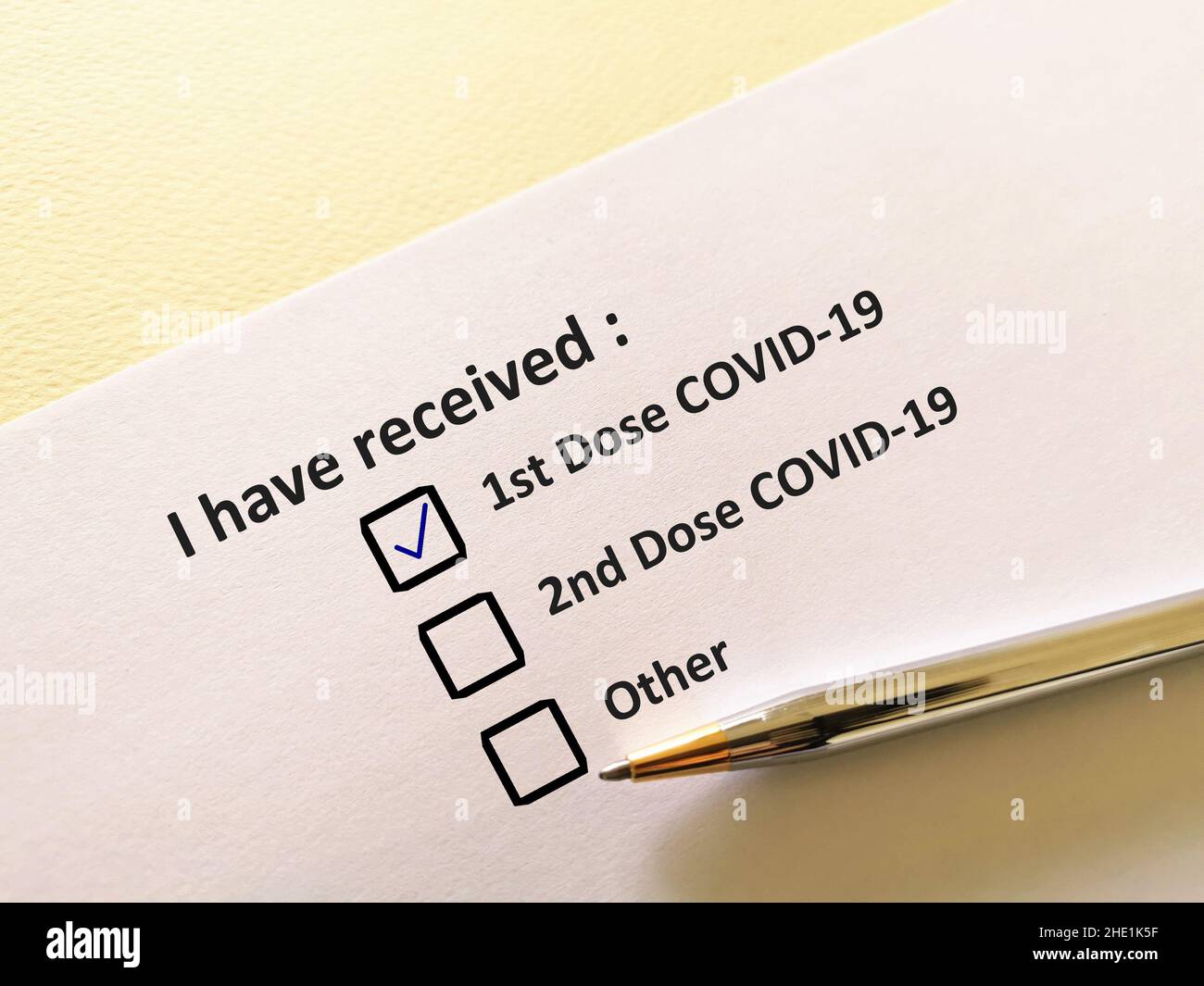 Eine Person beantwortet Fragen zu Impfstoffen. Die Person füllt die COVID-19-Karte auf. Stockfoto