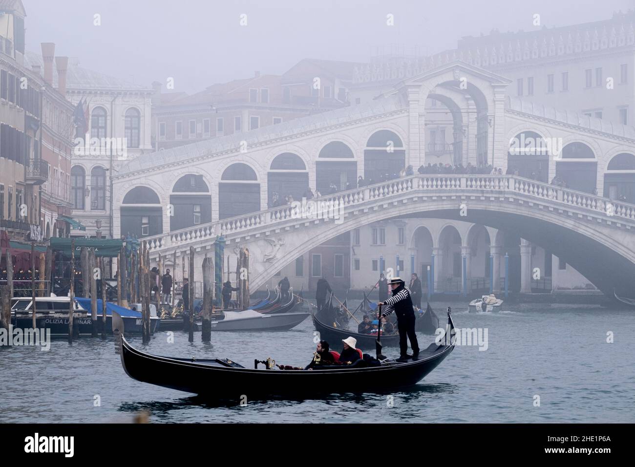 Ein Gondoliere rudern seine Gondel während einer Zeit des Nebels über den Canal Grande. Venedig, Italien, Dezember 30 2021. Stockfoto