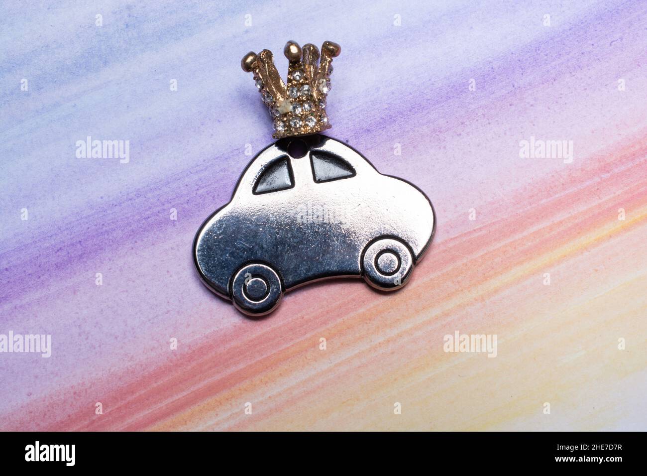 Nahaufnahme eines metallenen, autoförmigen Spielzeugs auf einem farbenfrohen Hintergrund Stockfoto