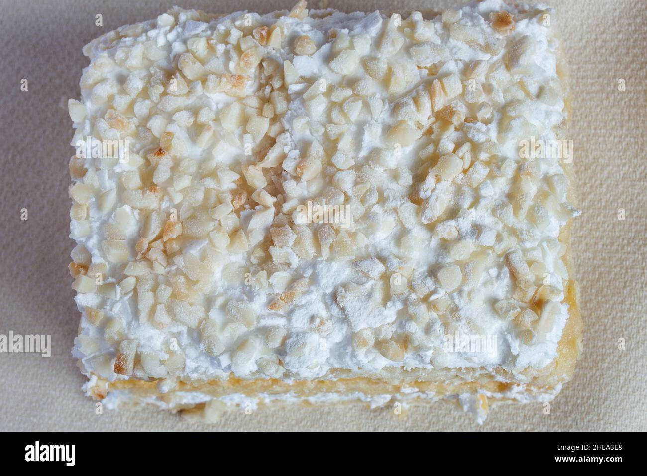 Blick von oben auf gehackte Mandeln mit Rahm und Baiser. Traditionelle süße Desserts und Texturen. Stockfoto