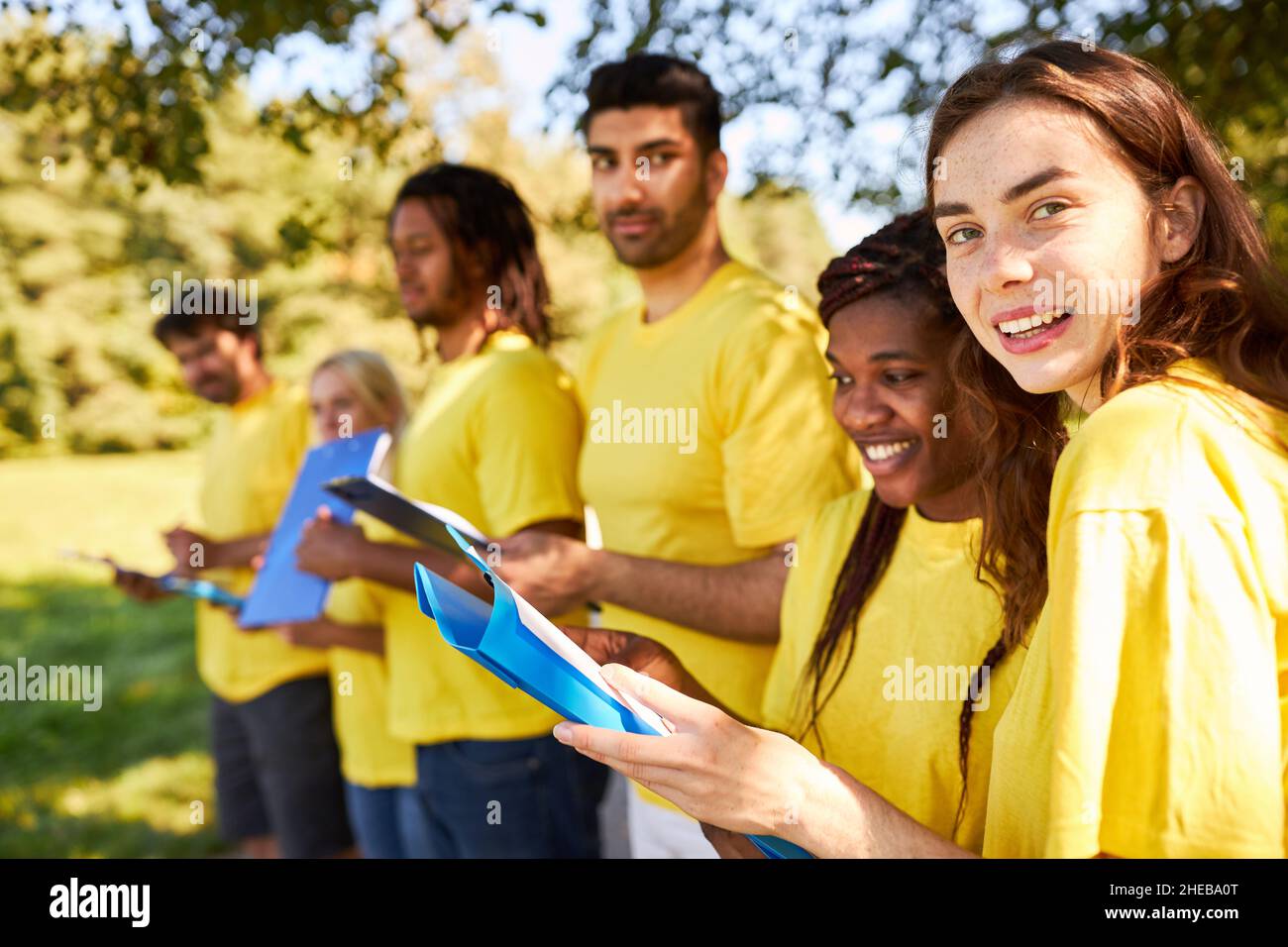 Freunde mit Clipboard als multikulturelles Team für ein Outdoor-Spiel im Sommer Stockfoto