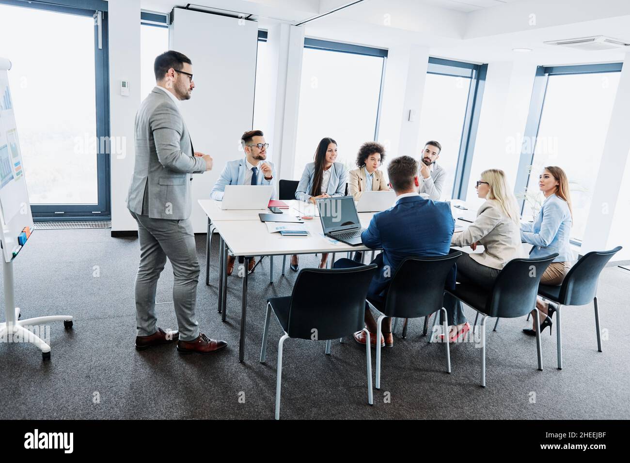 Junge Geschäftsleute treffen sich mit Kollegen des Whiteboard-Teams im Büro Stockfoto