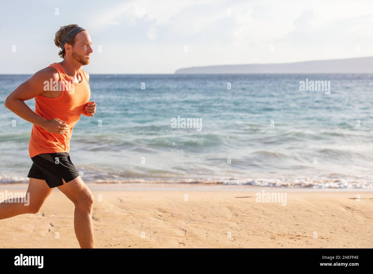 Laufsport Mann Profil des Athleten Training am Strand mit Landschaft Kopie Platz. Blick auf den Sonnenuntergang im Sommer Ozean. Bewegung aktiven Lebensstil Stockfoto