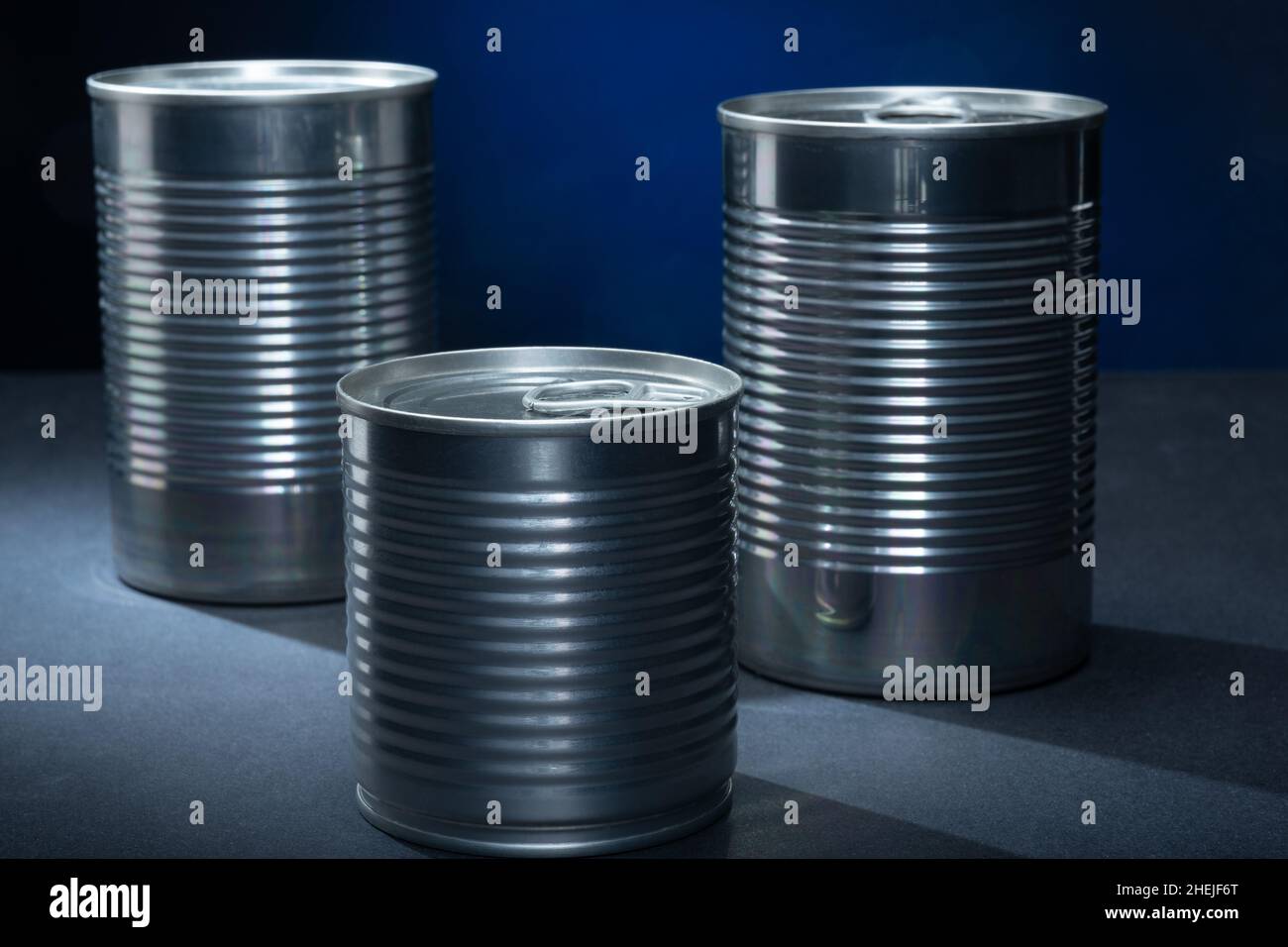 Helsinki / Finnland - 11. JANUAR 2022: Nahaufnahme von zwei Metalldosen vor blauem Hintergrund. Stockfoto