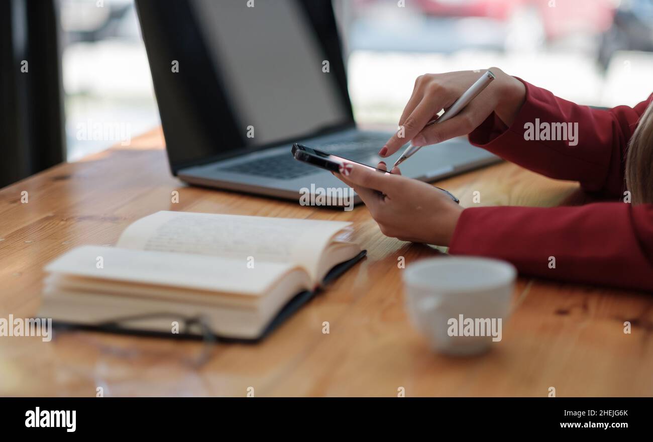 Nahaufnahme der Hände eines Mädchens, das eine Nachricht in ein Mobiltelefon schreibt, Business-Office-Konzept Stockfoto