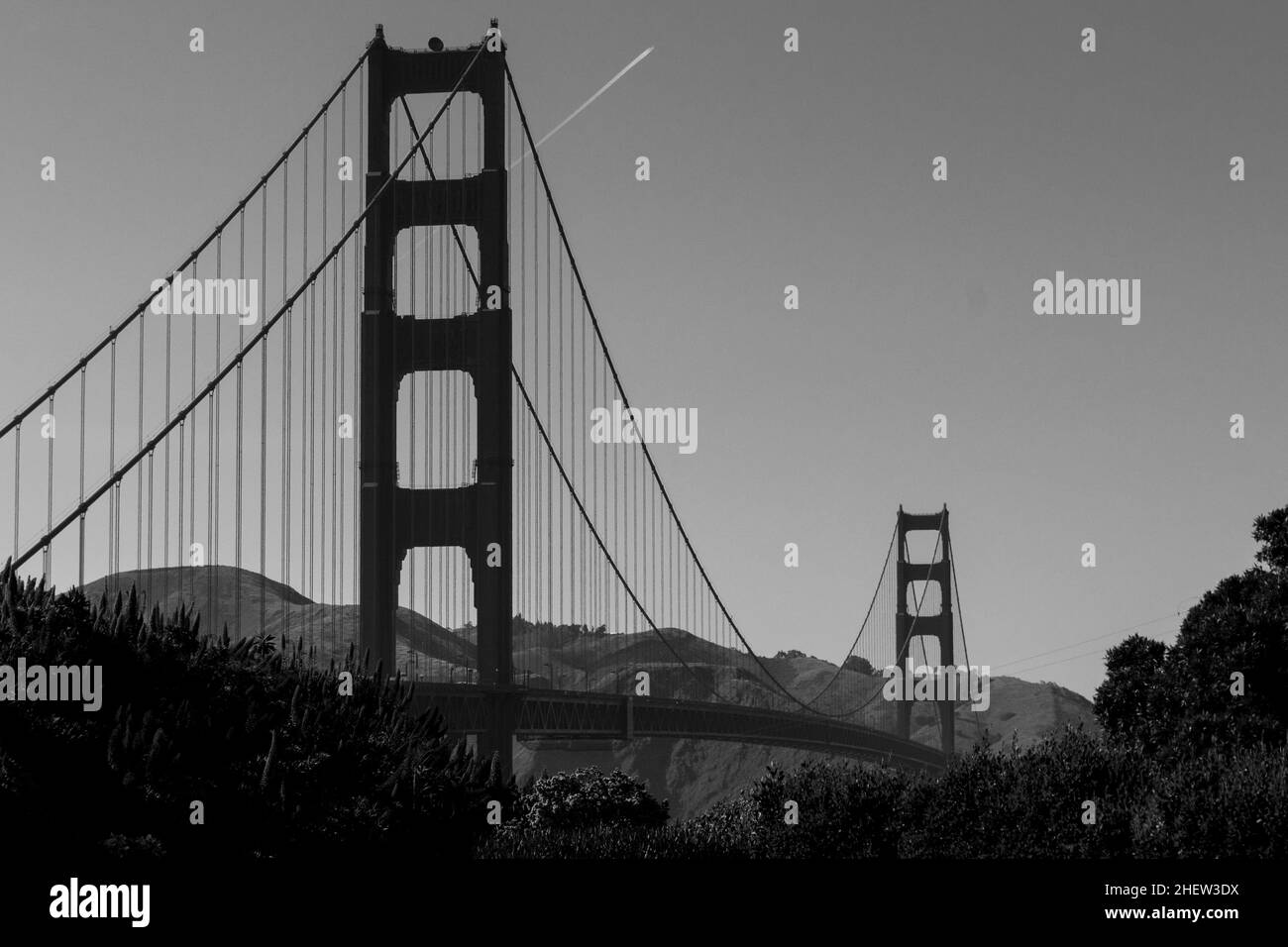 Schwarz und weiß von der Golden Gate Bridge mit Flugzeug am Himmel Stockfoto
