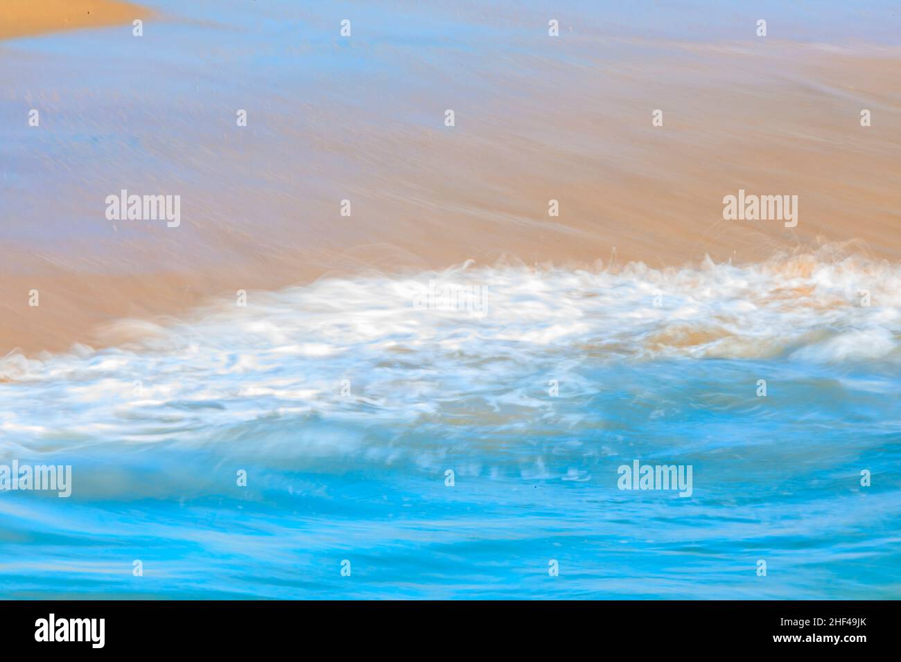 Abstrakte verschwommene Muster einer pazifischen Ozeanwelle am Strand in einem berühmten Touristenziel, Seal Beach in Kalifornien, USA, Langzeitbelichtung Stockfoto