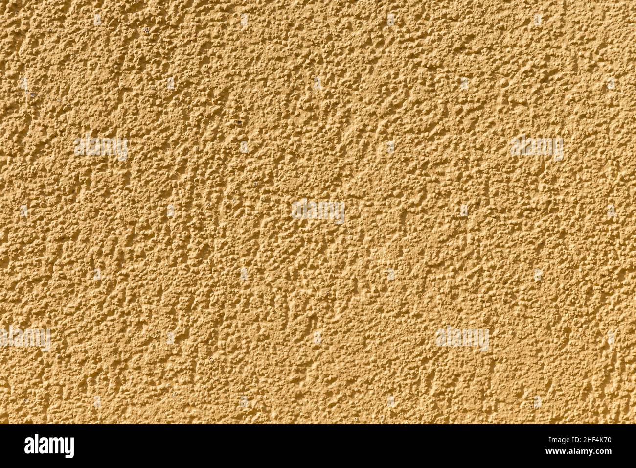 Ockerfarbener Wandhintergrund gibt ein harmonisches Muster Stockfoto