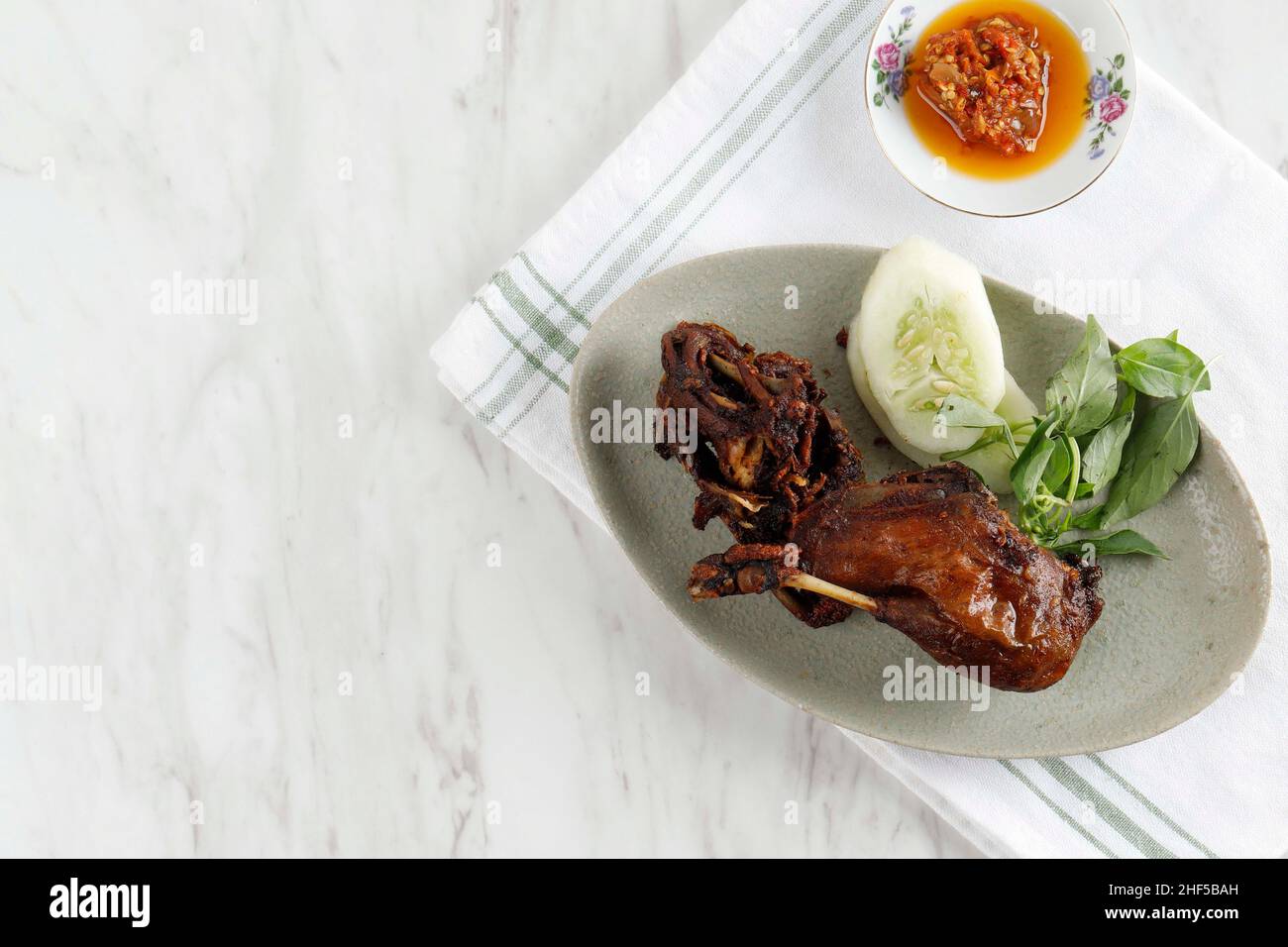 Bebek Goreng. Beliebtes indonesisches Gericht aus tiefgebratenen Enten, serviert mit Red Chili Paste. Kopierbereich für Text in der oberen Ansicht Stockfoto