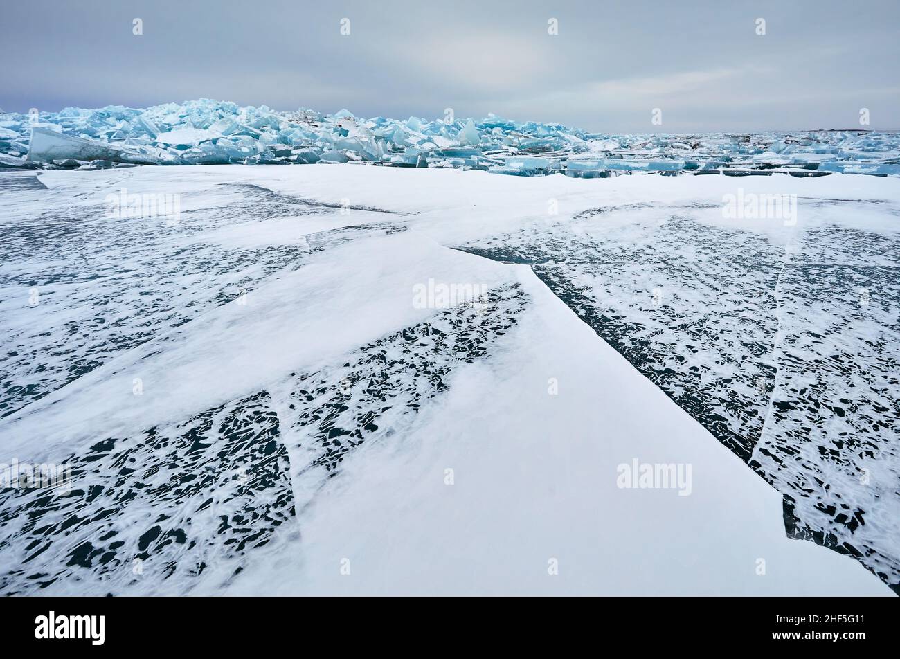 Schöne Landschaft von großen blauen Frieden des Eises Bummock und Risse an gefrorenen See mit Schnee Stockfoto