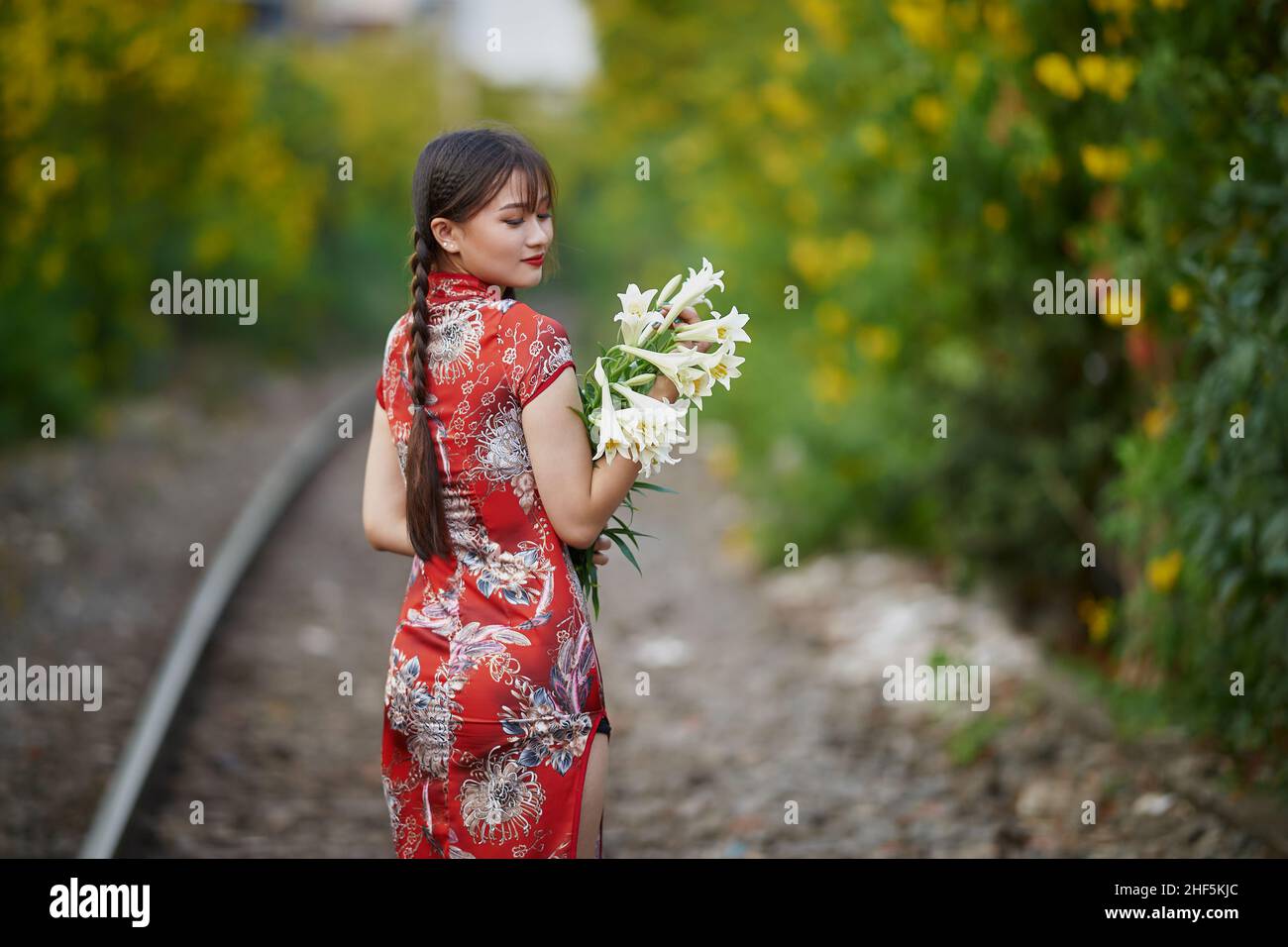 Ho-Chi-Minh-Stadt, Vietnam: Porträt eines schönen Mädchens mit rotem Cheongsam im Sonnenuntergang Stockfoto