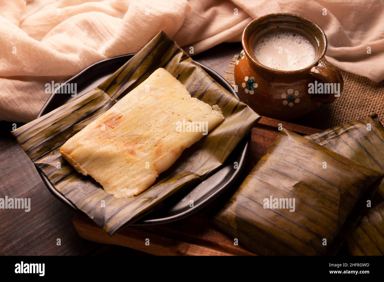 Prähispanische Gericht typisch für Mexiko und einige lateinamerikanische Länder. Maisteig in Bananenblätter gewickelt. Die Tamales werden gedämpft. Stockfoto