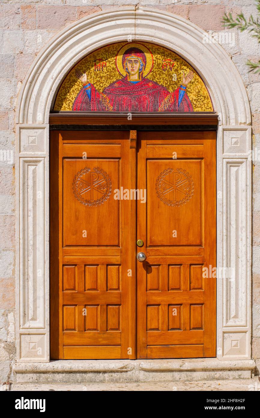 Farbenfroh verzierte hölzerne Kirchentür mit vielen komplizierten Details Stockfoto