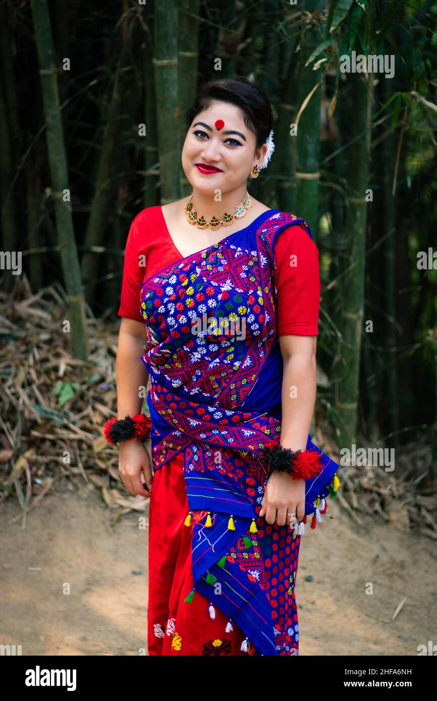 Mädchen lächelndes Gesicht isoliert in traditionellen tragen auf dem Festival mit verschwommenem Hintergrundbild gekleidet wird anlässlich der Bihu in assam indien aufgenommen. Stockfoto