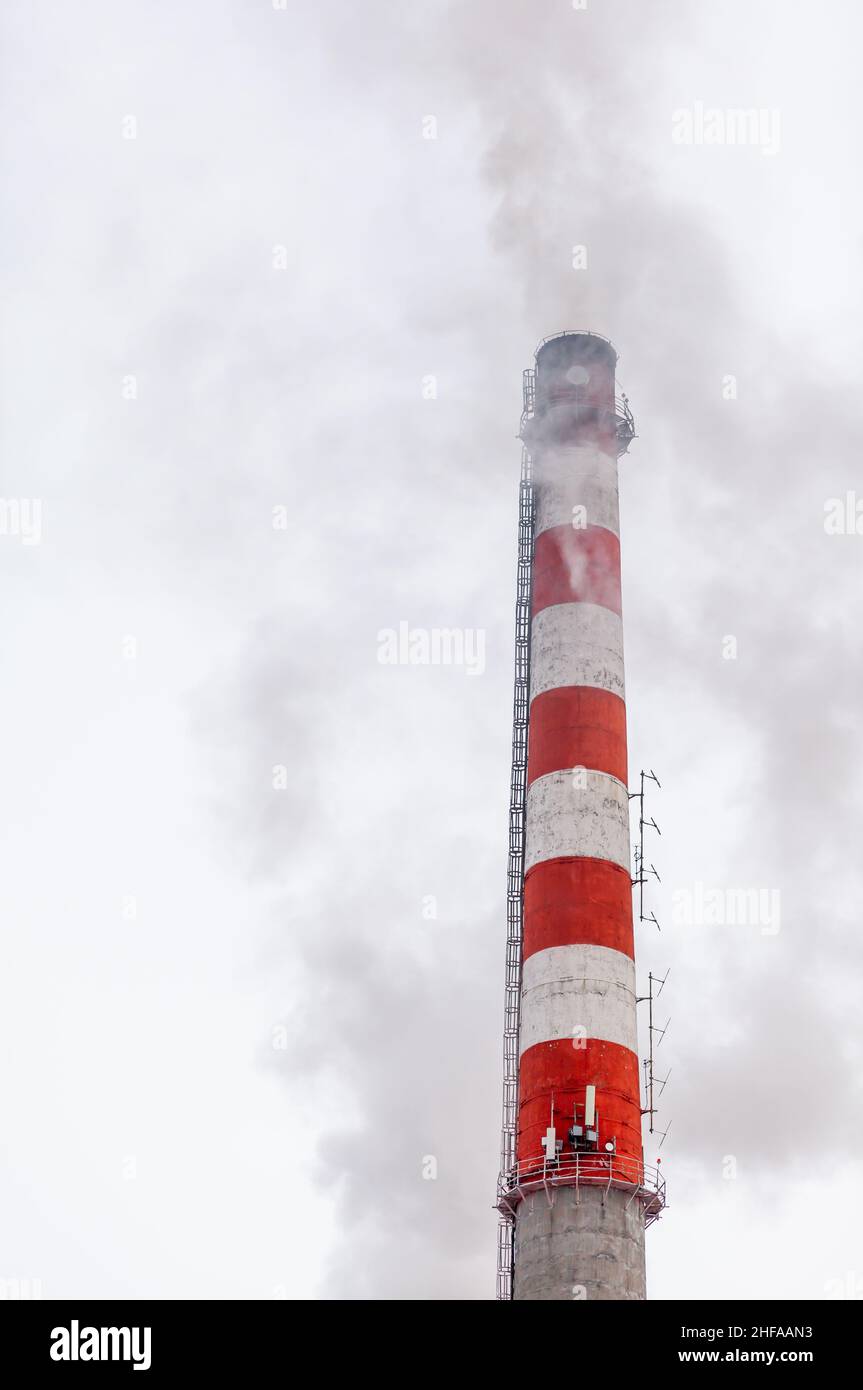Weißer dichter Rauch aus dem Kamin des Kesselraums. Rauch gegen den blauen Himmel. Luftverschmutzung. Heizung der Stadt. Industriegebiet. Stockfoto
