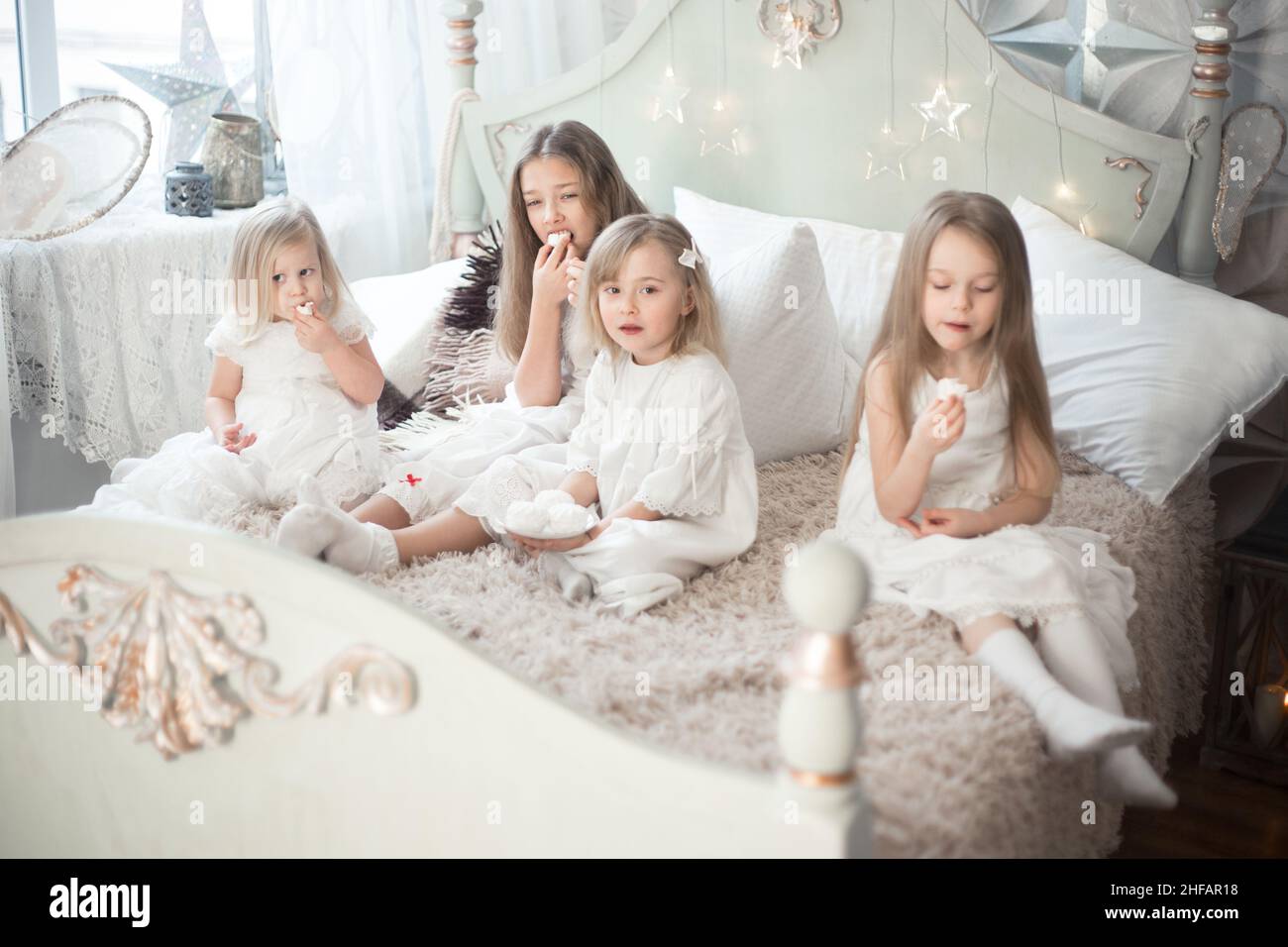 Mädchen Schwestern oder Freunde essen am Morgen im Schlafzimmer Süßigkeiten. Stockfoto