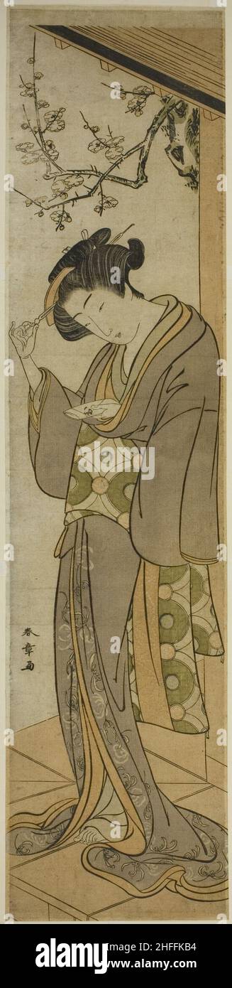Frau auf einer Veranda, die einen Brief öffnen wird, Japan, Mitte Ende 1770s. Stockfoto