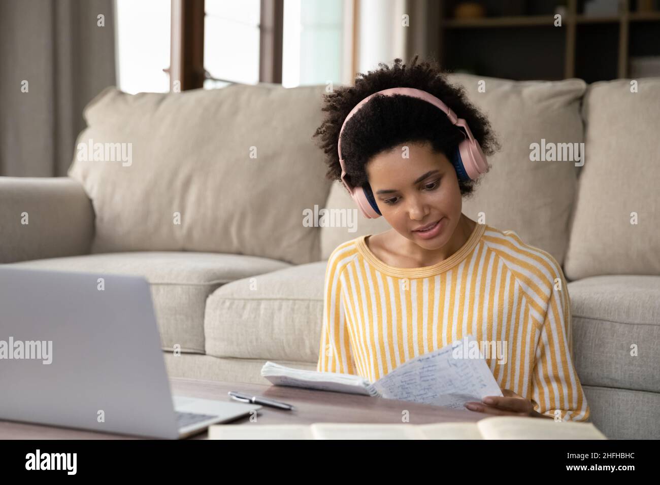 Glückliche junge afroamerikanische Frau E-Learning zu Hause. Stockfoto