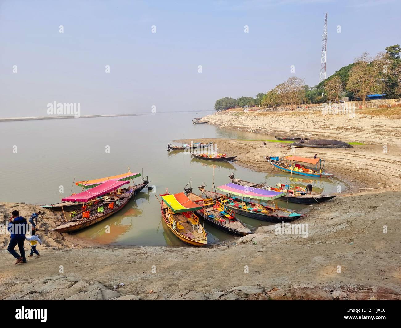 Lokale Holzboote fuhren entlang des Ufers des Meghna-Flusses und warteten auf Passagiere oder Touristen in Rajshahi, einer nordwestlichen Division in Bangladesch. Der Meghna-Fluss ist einer der größten Flüsse in Bangladesch, einer der drei Flüsse, die das Ganges-Delta bilden, das größte Delta der Erde, das sich bis in die Bucht von Bengalen erstreckt. Die Meghna entsteht durch den Zusammenfluss der Flüsse Surma und Kushiyara, die aus den hügeligen Regionen Ostindiens bis Chandpur stammen. Meghna wird hydrographisch als Oberes Meghna bezeichnet. Nachdem sich das Padma anschließt, wird es als die untere Meghna bezeichnet. Stockfoto