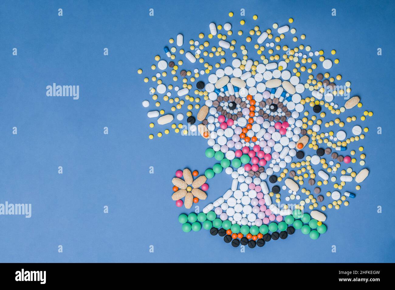 Mosaikzeichnung eines Mädchens, das mit medizinischen Pillen ausgekleidet ist. Stockfoto