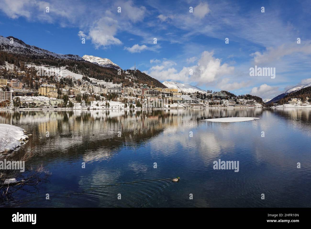 Dramatische Spiegelung des berühmten St. Moritzer Dorfes am See an einem sonnigen Wintertag im Kanton Graubünden in den alpen in der Schweiz Stockfoto