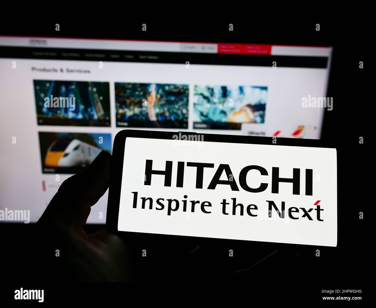 Person, die Smartphone mit Logo der japanischen Firma K.K. hält Hitachi Seisakusho auf dem Bildschirm vor der Website. Konzentrieren Sie sich auf die Telefonanzeige. Stockfoto