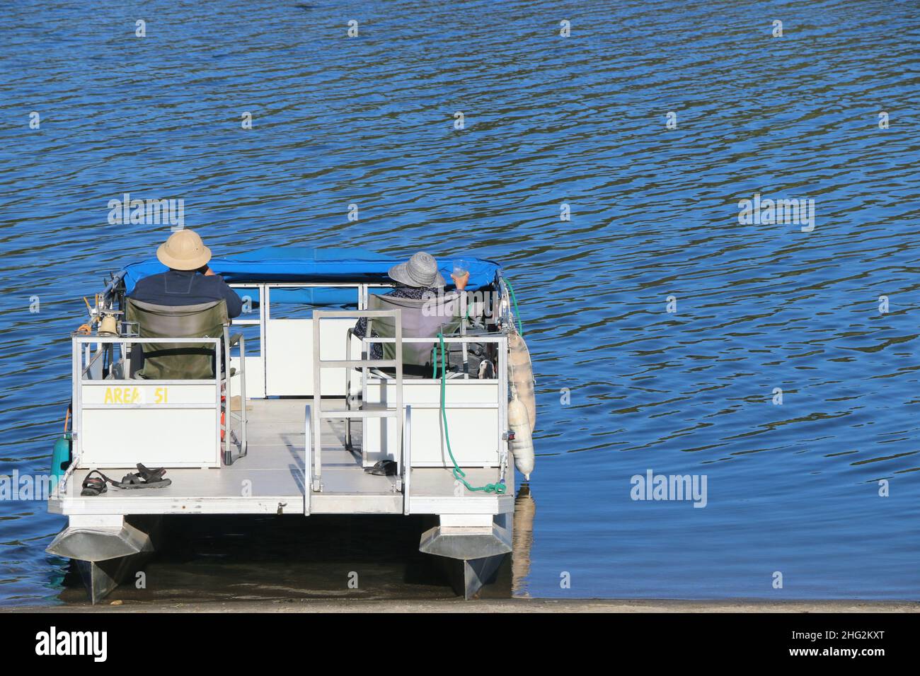 Pine Mountain Lake, CA: 11. Oktober 2021 – Ein älteres Paar genießt an einem Herbsttag Getränke in seinem Katamaran. Stockfoto