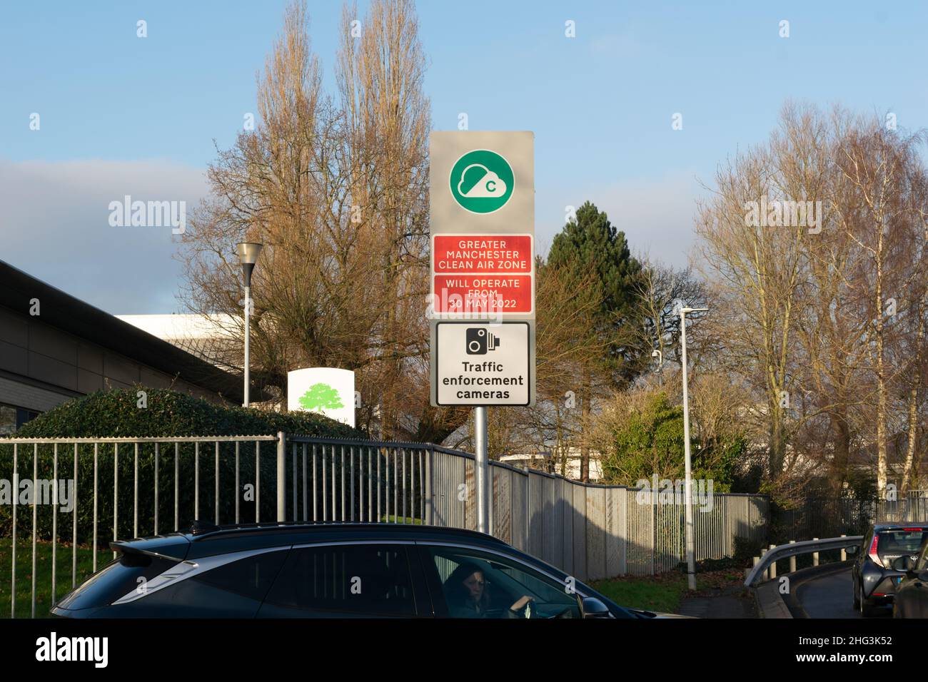 Schild für Greater Manchester Clean Air Zone in Cheadle mit nicht identifizierten Autos in der Warteschlange. Stockfoto