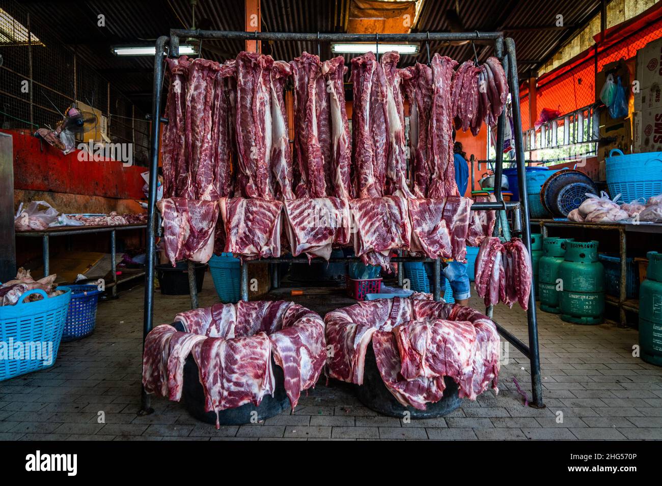 Bangkok, Thailand. 18th Januar 2022. Eine Ausstellung von frisch geschlachtetem Schweinefleisch vor dem Verkauf auf einem Markt in Bangkok.Arbeiter auf dem Bangkok Noi-Großmarkt bereiten am 18. Januar 2022 frisch geschlachtetes Schweinefleisch zum Verkauf vor. Aufgrund von Lieferengpässen, Marktspekulationen und einem möglichen Ausbruch der Afrikanischen Schweinepest steigen die Schweinefleischkosten in Thailand in die Höhe, was den Preis für Grundnahrungsmittel in die Höhe schiessen lässt. Die schnelle Inflation hat zu einem plötzlichen landesweiten Anstieg von Lebensmitteln von der Straße bis zum Supermarkt geführt. Kredit: SOPA Images Limited/Alamy Live Nachrichten Stockfoto