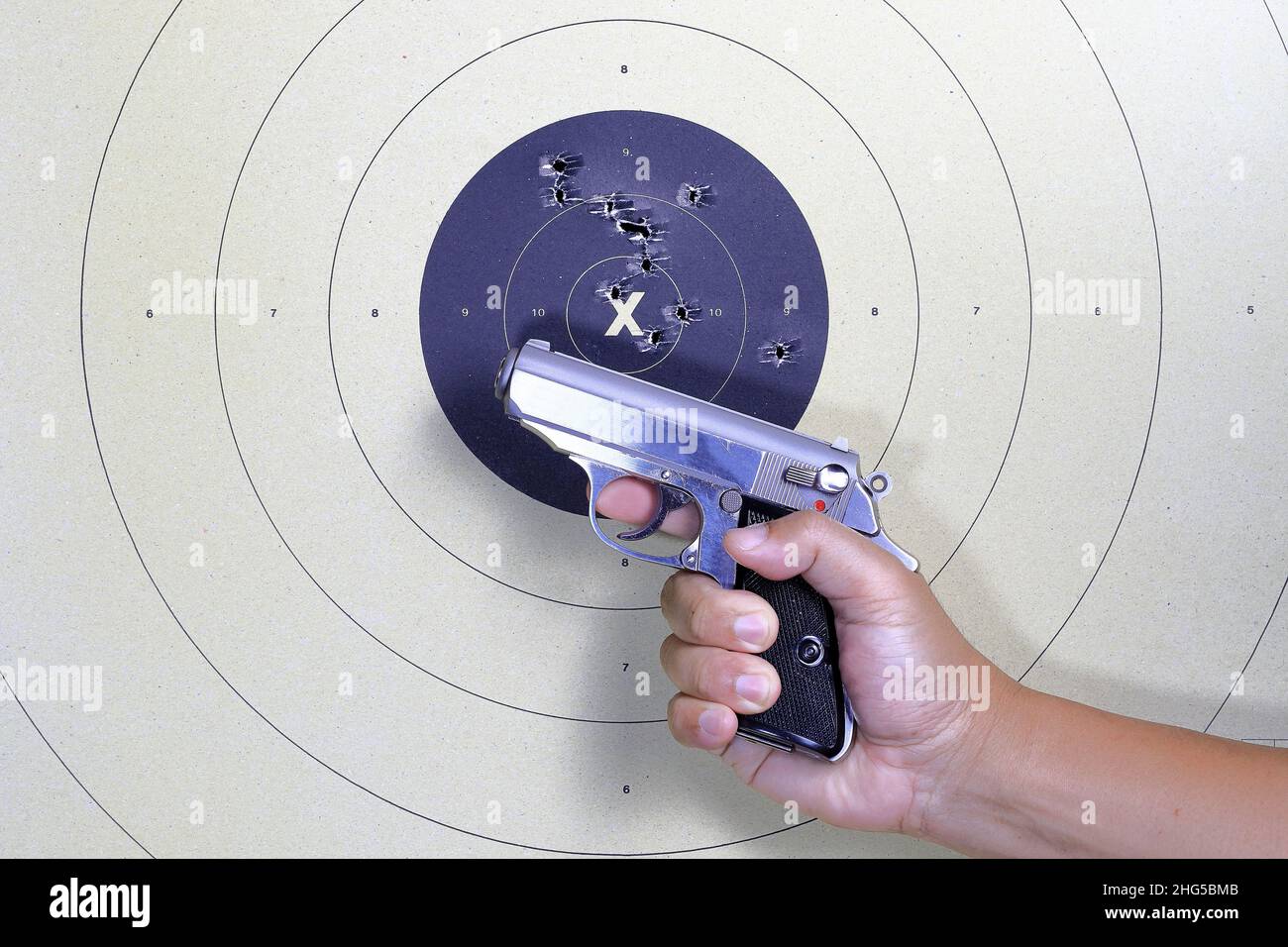 Pistole und Schießziel mit Bullet-Löchern. Klassisches Papierschießziel. Löcher Im Ziel. Für Sport, Jäger, Militär, Polizei. Sportschießen Kreis Stockfoto