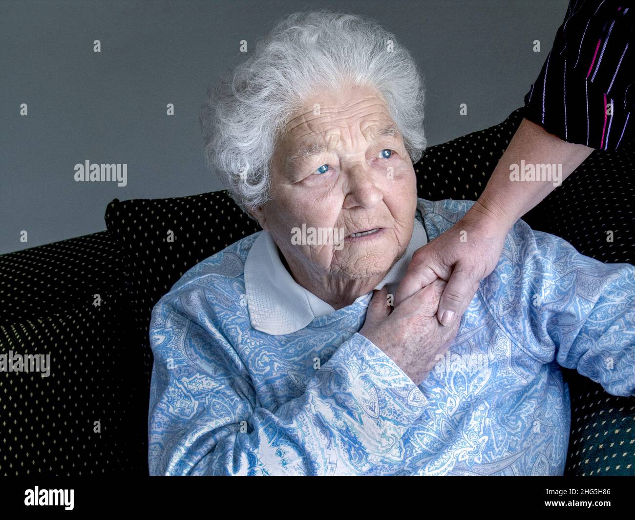 Ältere besorgt ältere alte Dame zu Hause traurig traurige medizinische Diagnose, hält tröstende Hand der Pfand in natürlichem Licht Innenraum Innenansicht Landschaft Stockfoto
