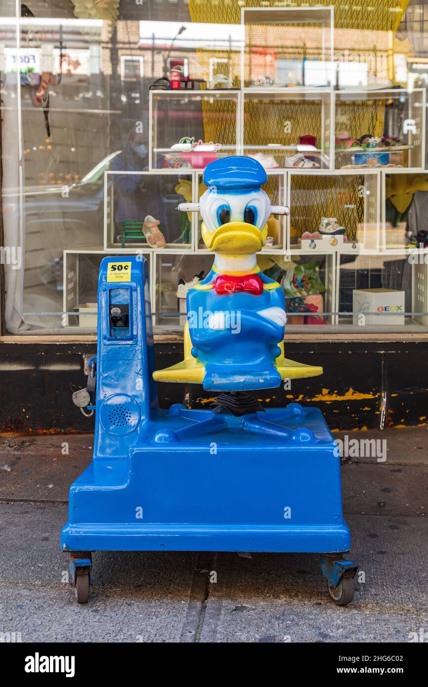 Brighton Beach, Brooklyn, New York City, New York, USA. 6. November 2021. Mechanische Donald Duck-Fahrt vor einem Geschäft. Stockfoto