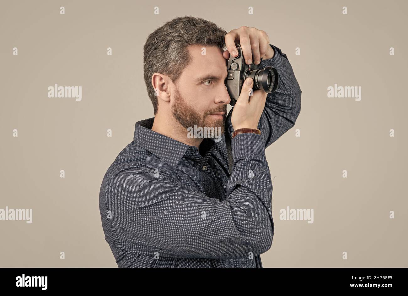 Es lohnt sich zu erfassen. Bärtiger Mann fotografiert mit der Kamera. Aufnahmesitzung. Fotosession Stockfoto