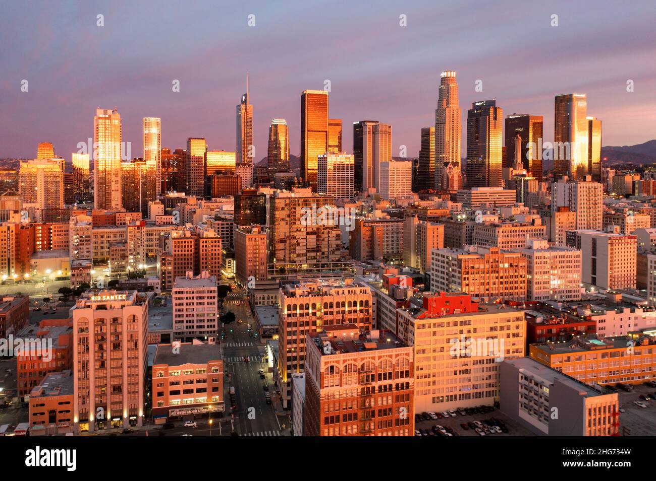 Luftaufnahme der Skyline eines erstaunlichen Sonnenaufgangs, der in den Gebäuden der Innenstadt von Los Angeles in Pink und Gold reflektiert wird Stockfoto