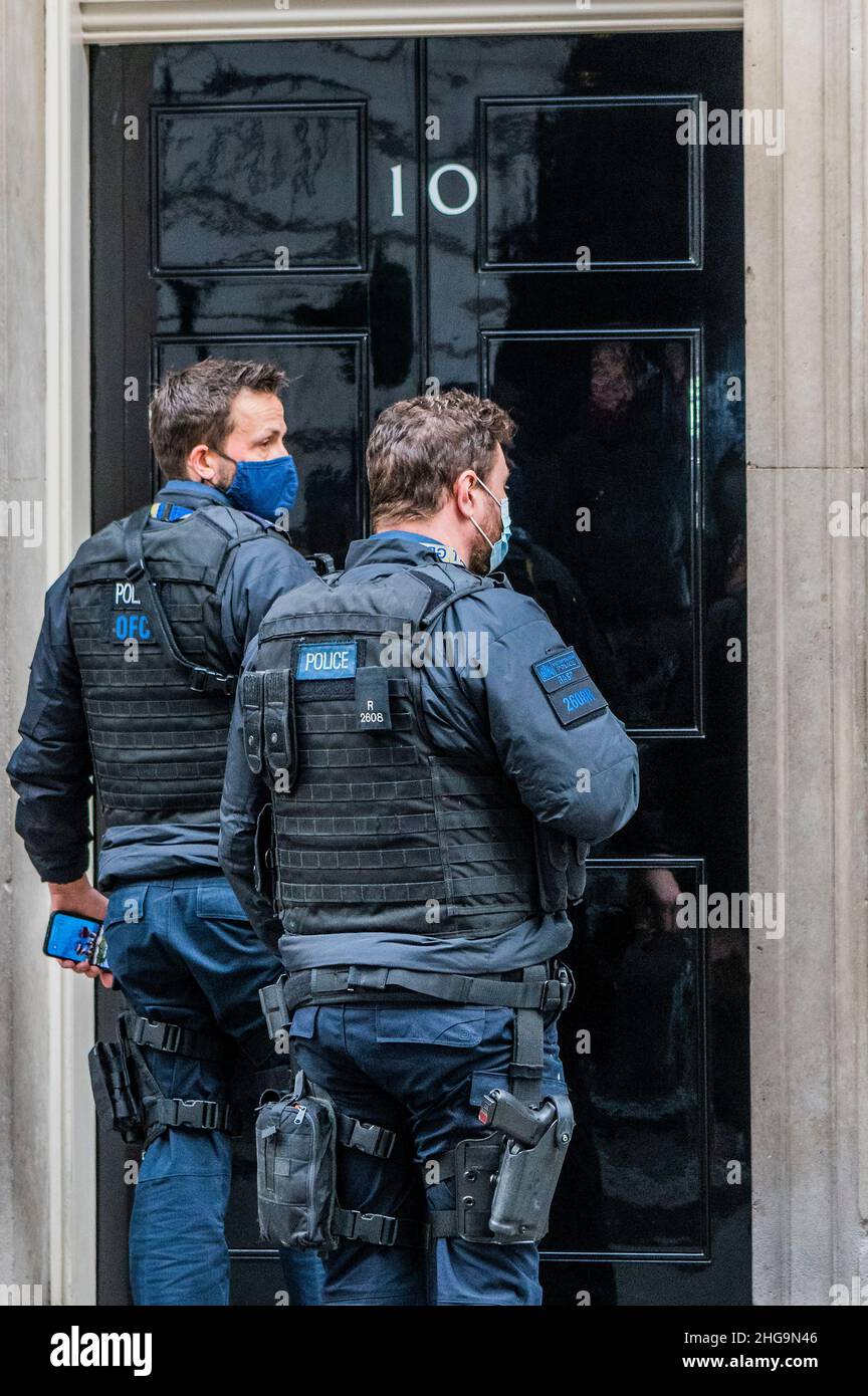 London, Großbritannien. 19th Januar 2022. Bewaffnete Polizisten kommen an die Tür der Nummer 10 - die Fragen zur Partygate, insbesondere die am 20. Mai 2020, gehen weiter. Boris Johnson leitet die Fragestunde seines dritten Premierministers (PMQ) des Jahres. Kredit: Guy Bell/Alamy Live Nachrichten Stockfoto London, Großbritannien. 19th Januar 2022. Bewaffnete Polizisten kommen an die Tür der Nummer 10 - die Fragen zur Partygate, insbesondere die am 20. Mai 2020, gehen weiter. Boris Johnson leitet die Fragestunde seines dritten Premierministers (PMQ) des Jahres. Kredit: Guy Bell/Alamy Live Nachrichten Stockfoto