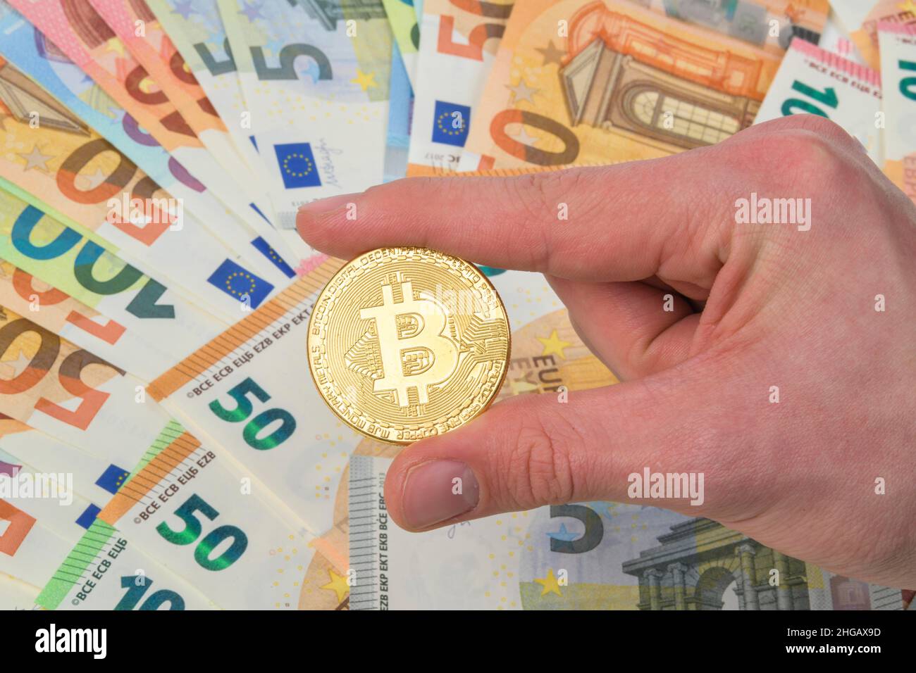 Bitcoin-Münze, Euro-Banknoten, Studioaufnahme Stockfoto