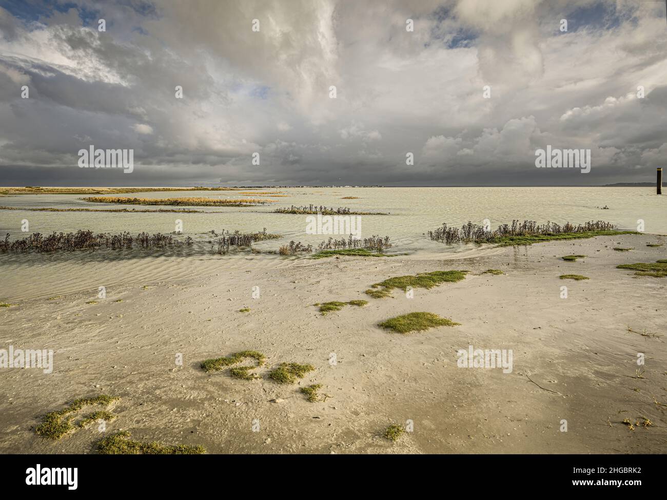 Baie de Somme, le Hourdel, chenal à marée basse, blockhaus, coucher de Soleil sur la mer , sable et balise. Stockfoto