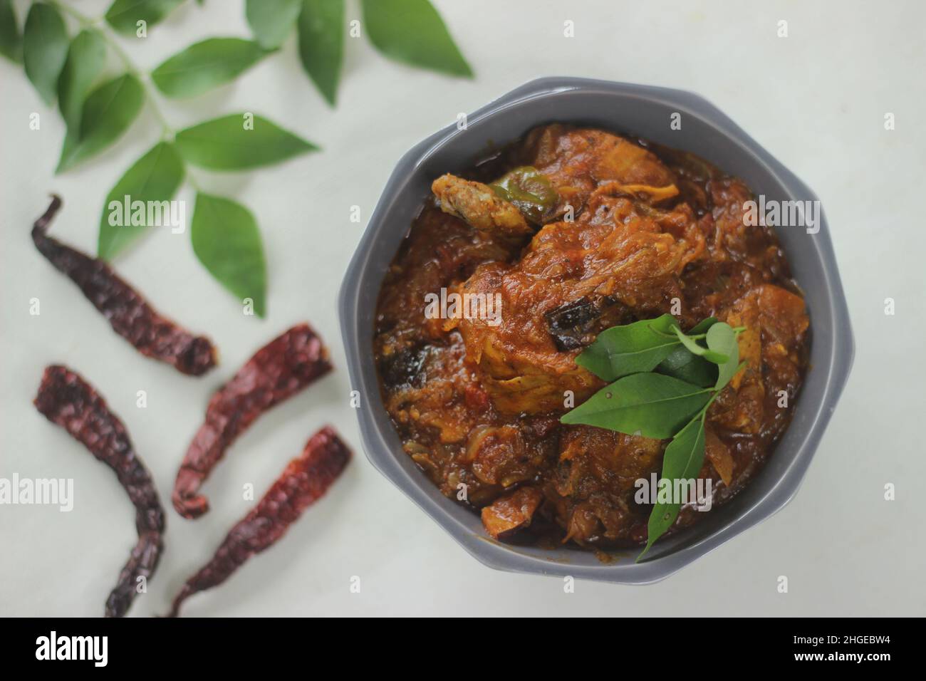 Chicken Soße. Halbtrockene Chicken Sovy im Kerala-Stil mit Zwiebeln, Tomaten und Gewürzen zubereitet. Aufgenommen auf weißem Hintergrund Stockfoto