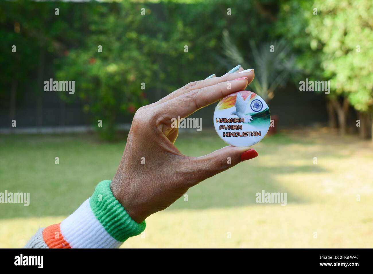 Weibliche Person mit indianischem Abzeichen mit der Aufschrift „humara pyara hindustan“, was unser schönes Indien bedeutet. Person, die den Tag der indischen Unabhängigkeit oder den Tag der Republik wünscht Stockfoto