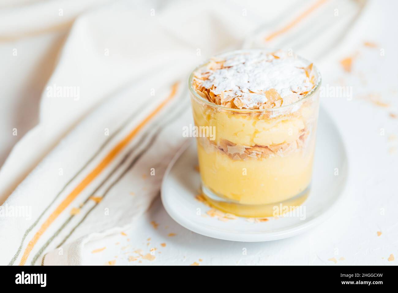 Vanillepudding Dessert namens Krempita serviert auf unterschiedliche Weise in einem Glas auf einem hellen Hintergrund Stockfoto