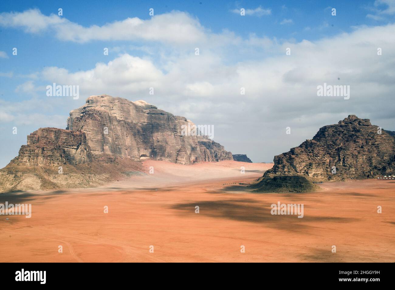 Wüstenlandschaft des Wadi Rum, einer Schlucht in Jordanien mit rotem Sand und Felswänden. Stockfoto