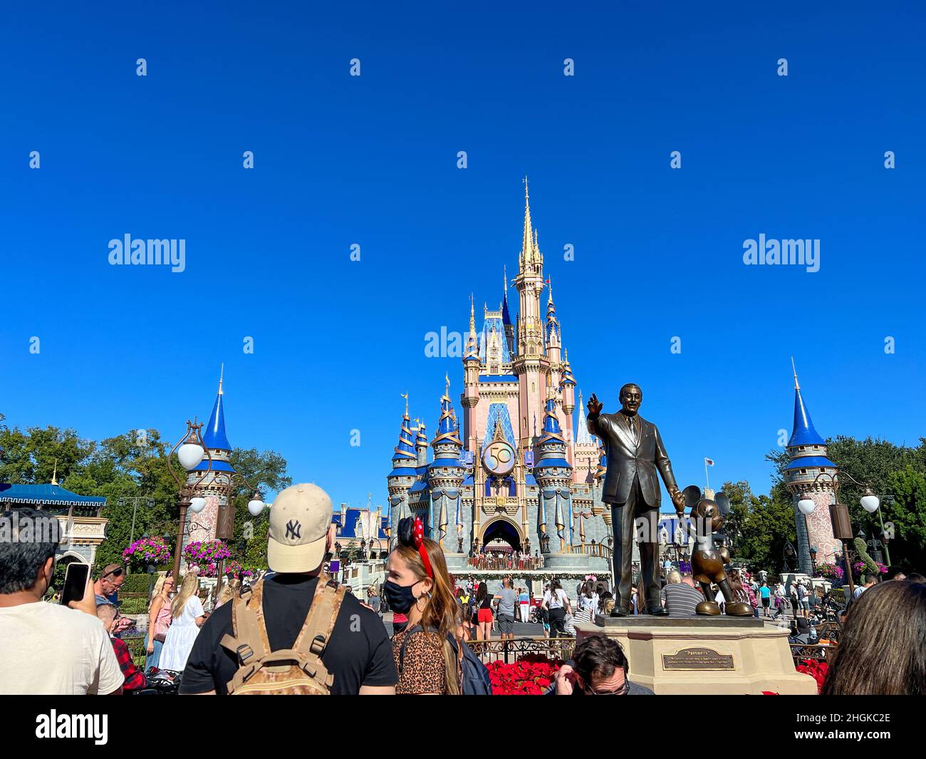 Orlando, FL USA - 2. Dezember 2021 : Menschen, die zu Weihnachten in Richtung Cinderella Castle gehen, im Walt Disney World Magic Kingdom in Orlando, Florida. Stockfoto