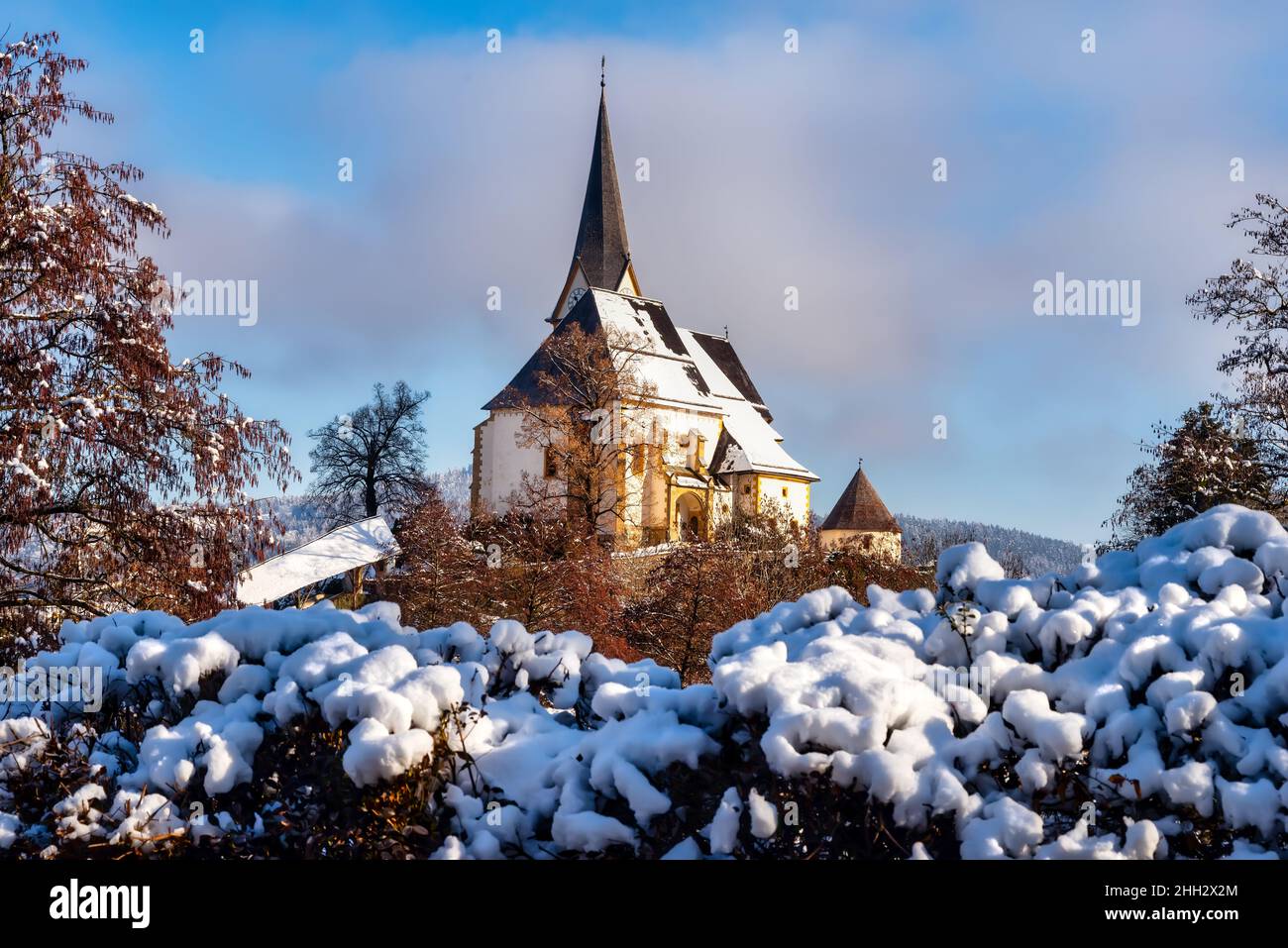 Idyllischer Blick auf die Wallfahrtskirche in Maria Worth im Winter, Kärnten, Österreich. Pfarrkirche Mariae Himmelfahrt, Österreich Stockfoto