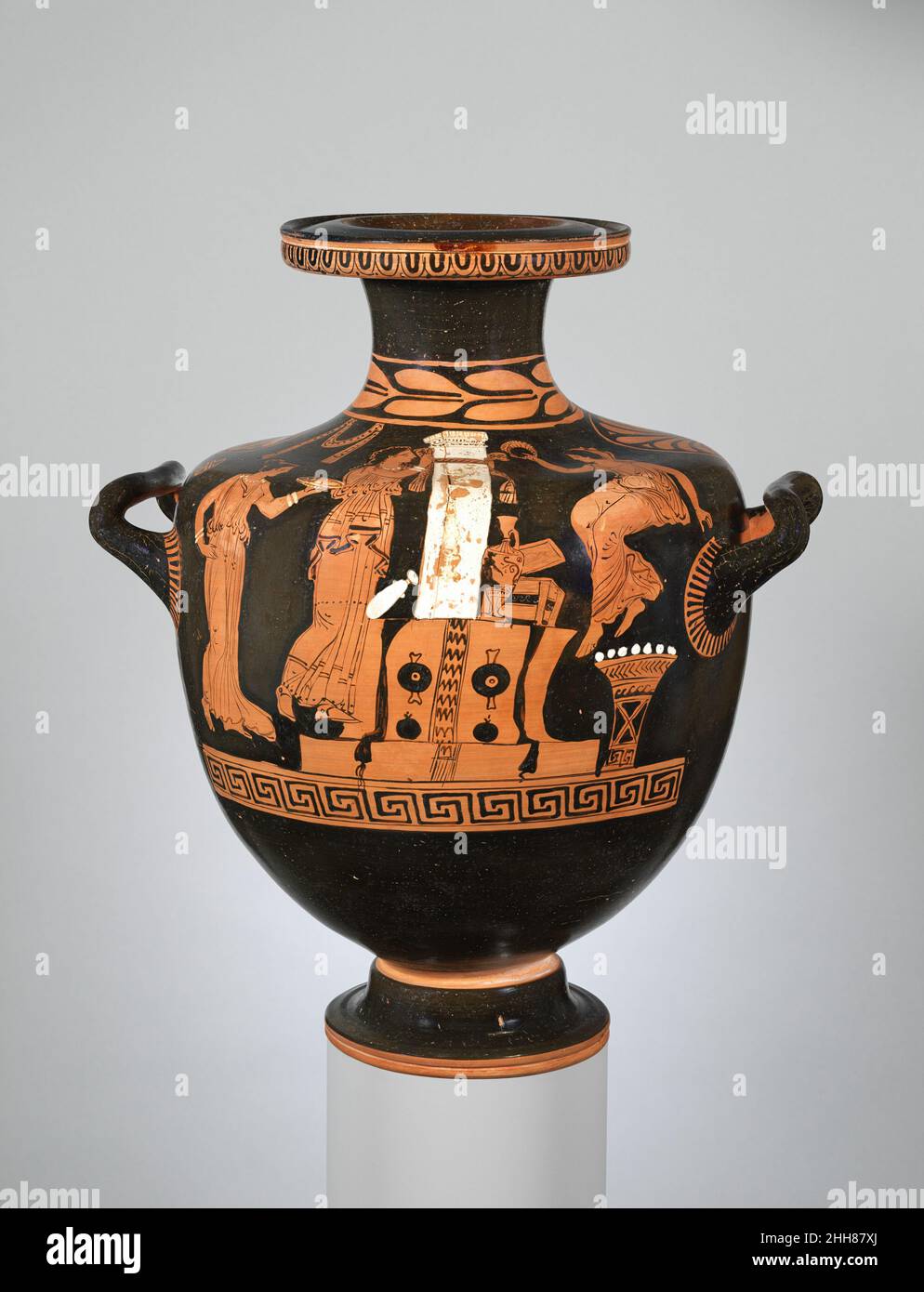 Terrakotta-Hydria (Wasserbehälter) ca. 375–350 v. Chr. zugeschrieben der Werkstatt der Iliupersis-Malerin an einem GrabbeigabeObwohl es in der süditalienischen Vasenmalerei reichlich Grabszenen gibt, zeigen nur wenige Aktivitäten an einem Grabbeiplatz. In einer seltenen Ausnahme zeigt diese Vase eine Frau, die ein Filet um das säulenförmige Denkmal bindet, während die beiden anderen ein Trankopfer gießen und sich darauf vorbereiten, einen Kranz zu platzieren. Die Art der Grabmarkierung und die Widmungen sind vergleichbar mit denen, die mit den athenischen Lekithoi (Ölgefäßen) und Stelai assoziiert werden, mit Ausnahme der hier vorstehenden Granatäpfel. Terrakotta-Hydria (Wasserbehälter). Griechisch, Süditalien Stockfoto