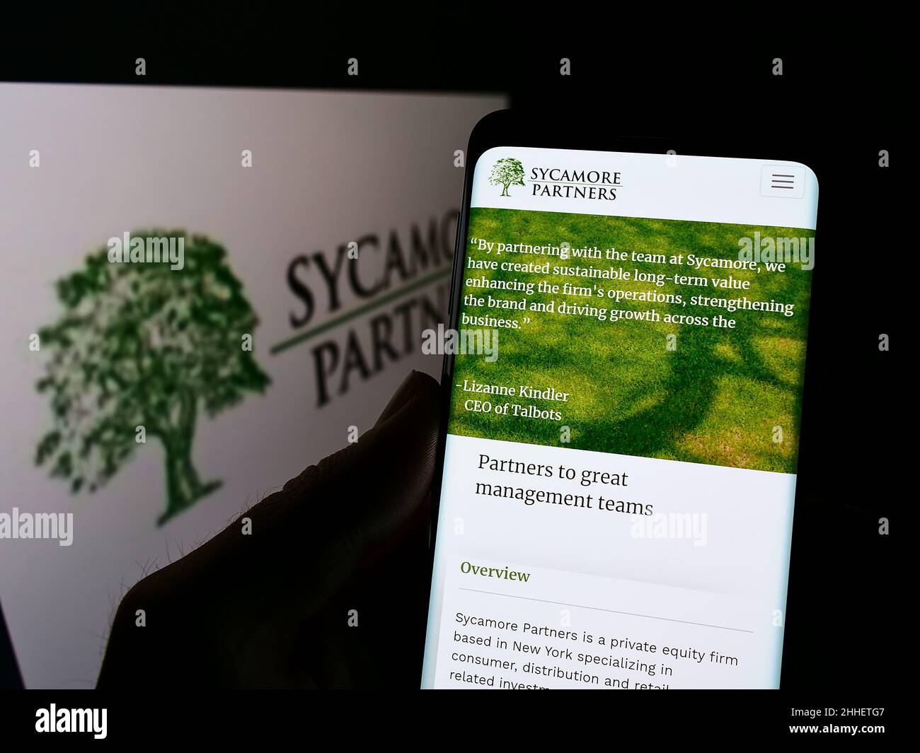 Person, die Mobiltelefon mit der Webseite des US-amerikanischen Private-Equity-Unternehmens Sycamore Partners auf dem Bildschirm vor dem Logo hält. Konzentrieren Sie sich auf die Mitte des Telefondisplays. Stockfoto