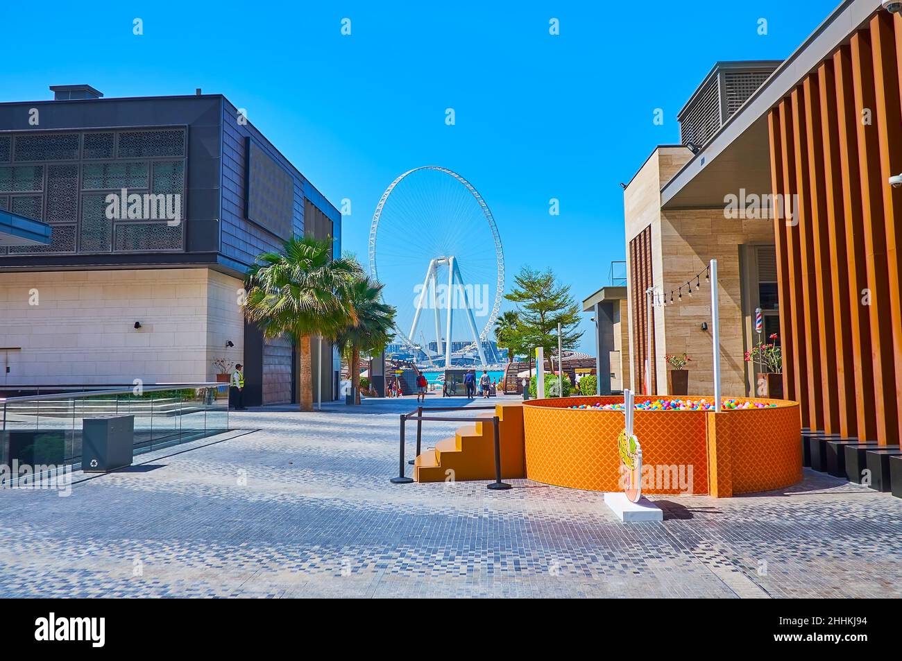 Das moderne Riesenrad Ain Dubai ist hinter den Einkaufszentren der Fußgängerzone JBR Marina Beach Walk in Dubai, VAE, zu sehen Stockfoto