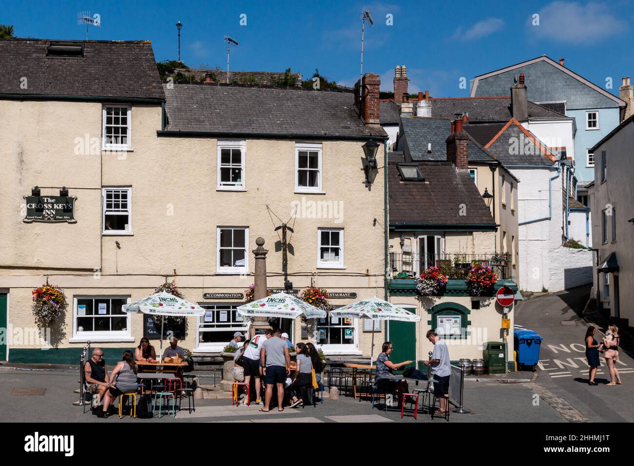 Leute, die sich vor dem Cross Key Inn in The Square, Cawsand, Cornwall treffen. Während der Covid-Pandemie war es beliebt, außerhalb von Pubs vorübergehend zu sitzen. Stockfoto