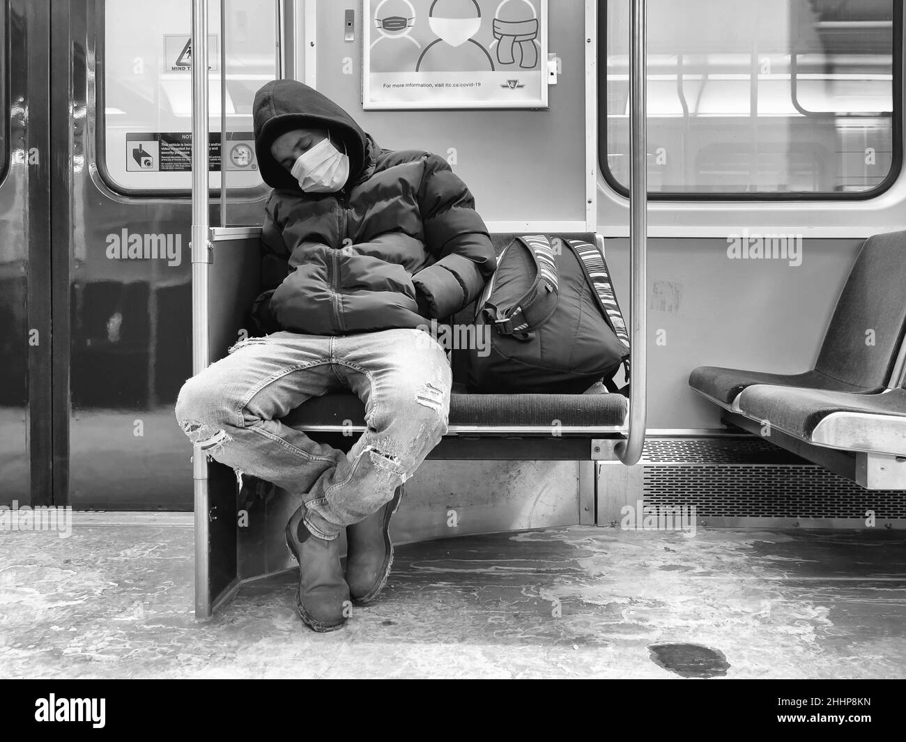 Toronto, Kanada, 22. Januar 2022: Ein Mann, der in einem U-Bahn-Zug mit Schutzmaske schläft Stockfoto
