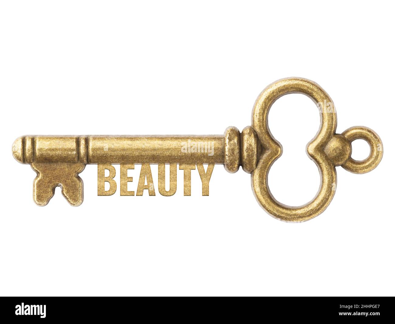 Antike Schlüssel aus Bronze mit Wort Schönheit auf weißem Hintergrund isoliert. Konzept Möglichkeit und Kapazität Stockfoto